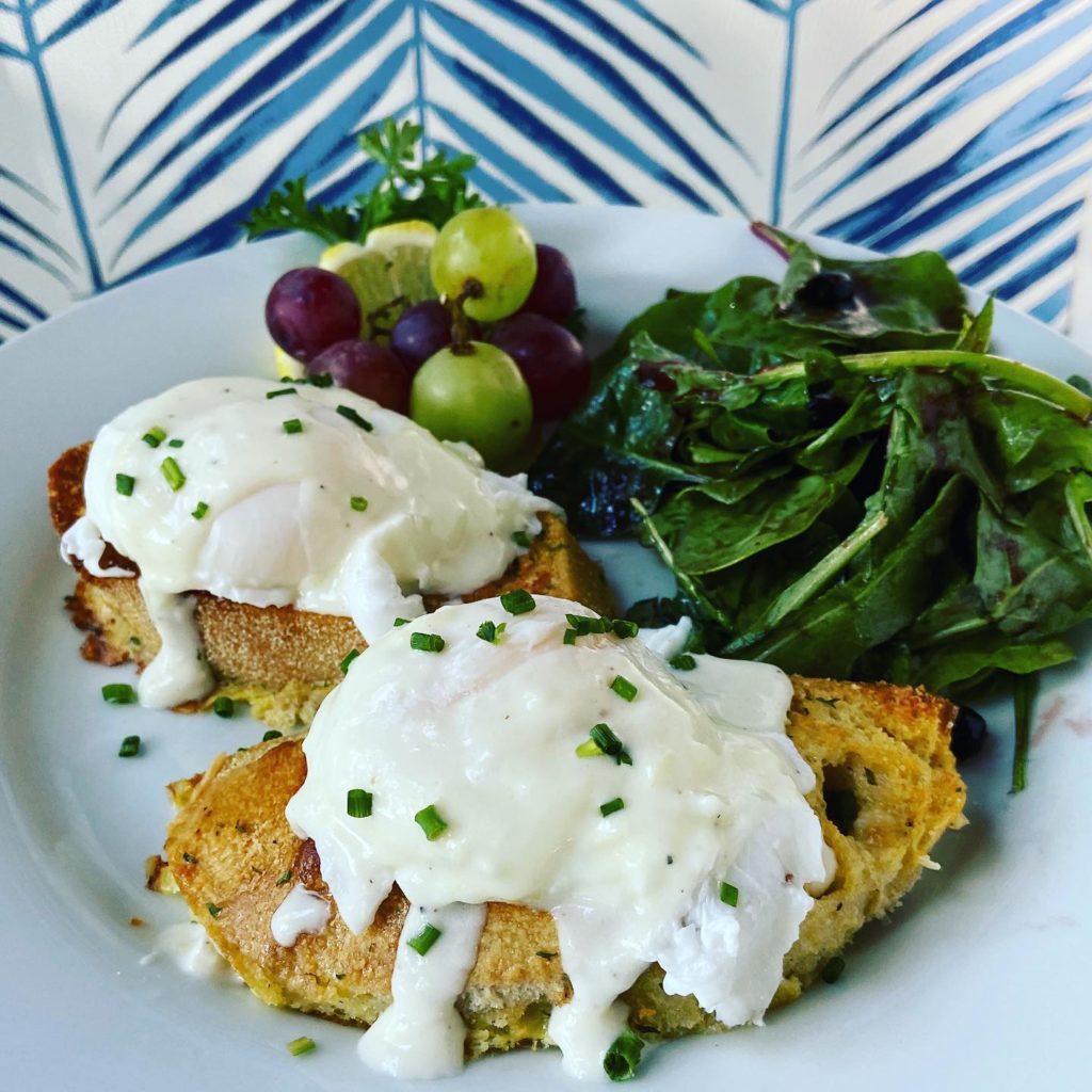 Parmesan “French toast” with poached eggs w Mornay and blueberry dressed greens